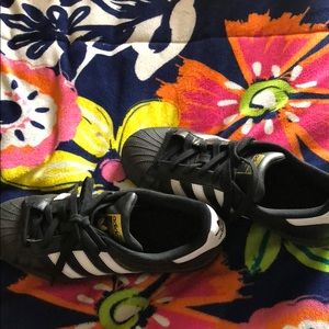 Black and white Adidas superstars